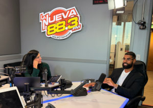 two people sitting at a radio desk